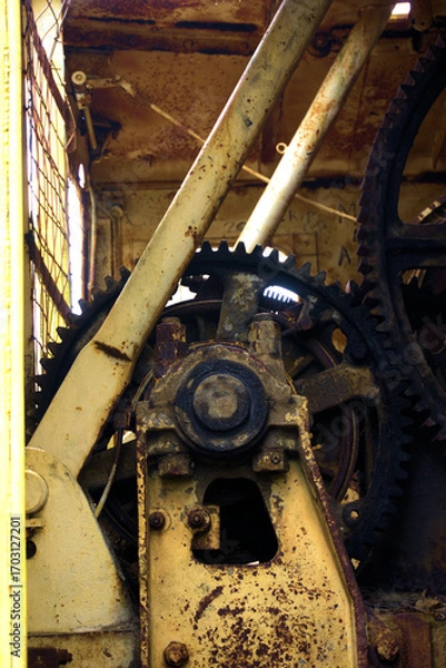 Fototapeta old rusty gear train on old mining equipment 