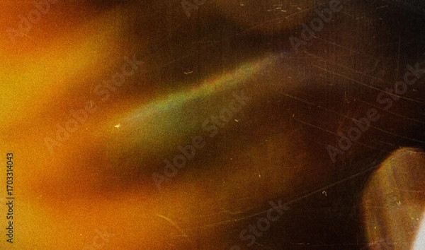 Fototapeta Grainy colorful warm rainbow red light leaks on black background with dust texture. abstract damaged scratched retro film analog effect for using over photos as overlay or screen filter