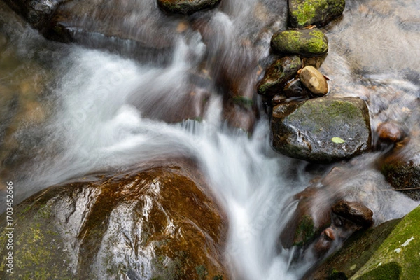 Obraz Slow shutter of the river flowing between rocks, in Keelung city, Taiwan.