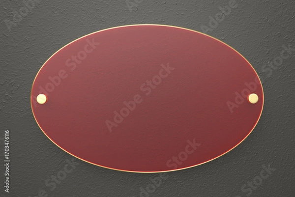 Fototapeta Oval red glass nameplate with golden edge on dark grey wall, front view
