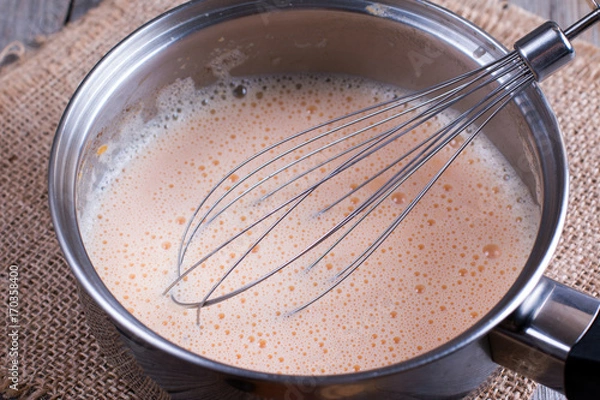 Fototapeta Preparation of pumpkin latte in a saucepan