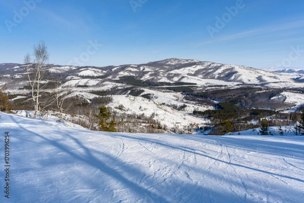 Fototapeta View of the Ural Mountains from a ski slope on a frosty winter day near the village of Abzakovo.