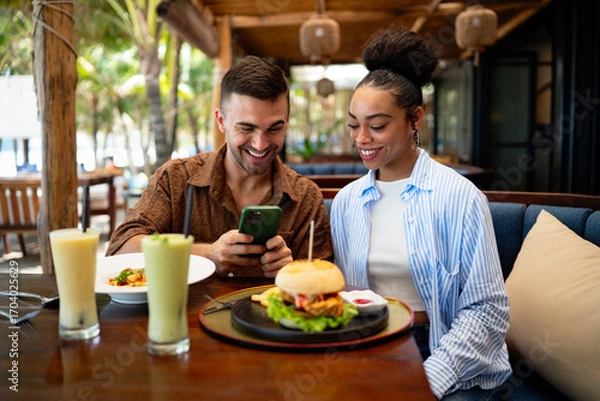 Fototapeta A diverse couple creates social proof as content drives reviews, bookings, loyalty and growth