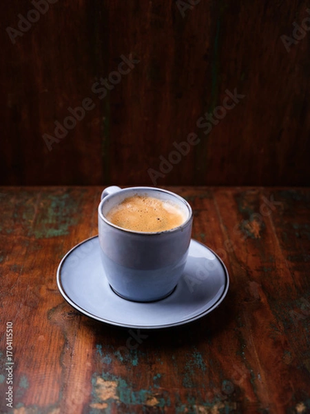 Fototapeta Cup of coffee on rustic wooden background. Soft focus. Copy space	