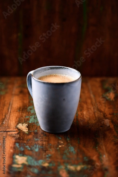 Fototapeta Cup of coffee on rustic wooden background. Soft focus. Copy space	