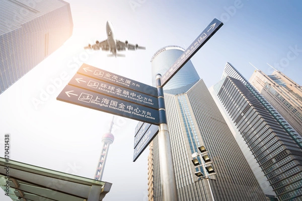Obraz the modern building with airliner at dusk in shanghai, China.
