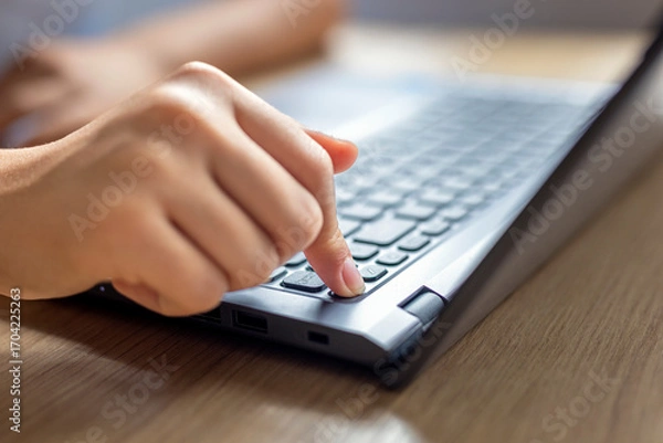 Fototapeta Computer button on and off. Confirmation by button on the keyboard on a laptop when working and studying and social media