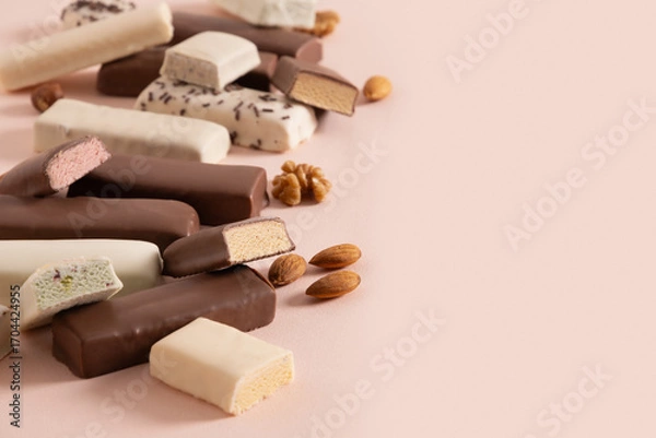 Fototapeta Tasty whey protein bars with various chocolate coatings and sprinkles on pink background. Close up. Copy space.