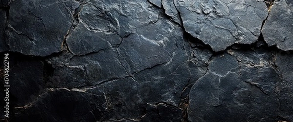 Fototapeta close-up view of cracked dark slate stone surface with natural fractures and texture