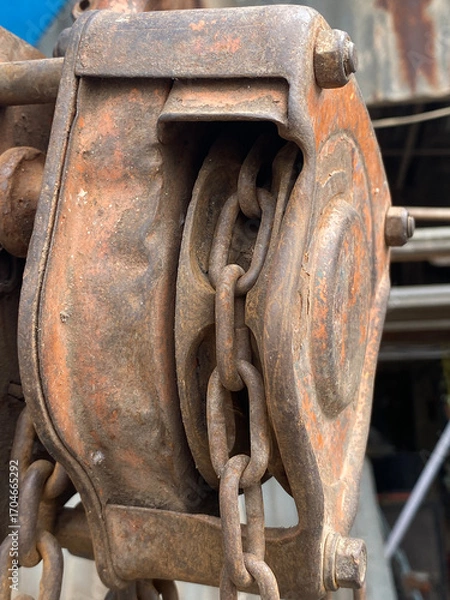 Fototapeta detail of a rusty machine, reel and chain