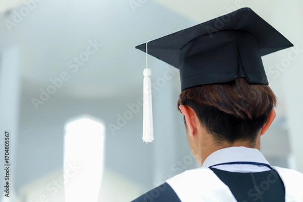 Fototapeta Back view of graduates celebrating their college graduation with pride and joy on graduation day. Congratulations.