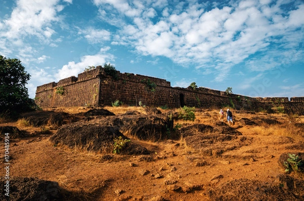 Fototapeta Tourists go to the ruins of Chapora fort, located near Vagator village, North Goa, India