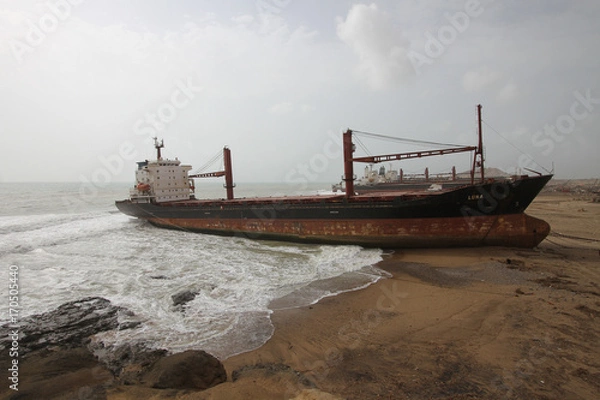 Obraz Huge cargo ship run ashore in ship breaking yard