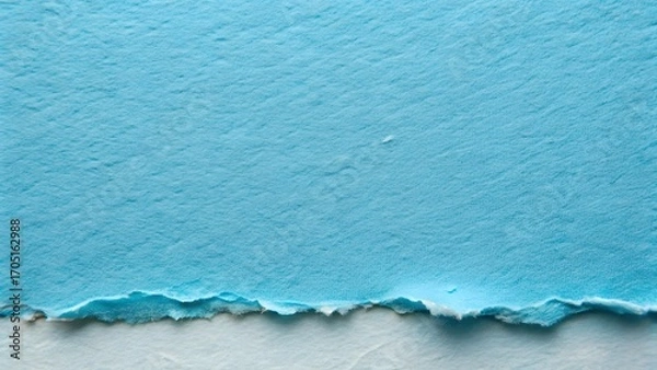 Fototapeta Close-up textured surface of torn light blue handmade paper with rough edges on white background