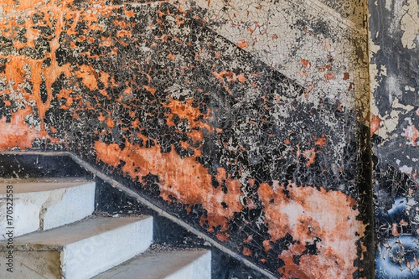 Fototapeta Abandoned building with concrete stairs and a colorful wall