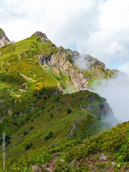 Fototapeta clouds high in the mountains in summer