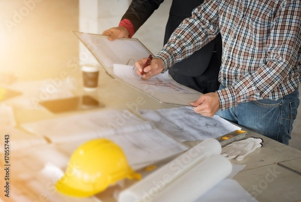 Obraz Team of Businessman /engineering in construction renovate building site. Engineer/architect inspection workplace for project.Teamwork construction engineer,business and architecture concept. 