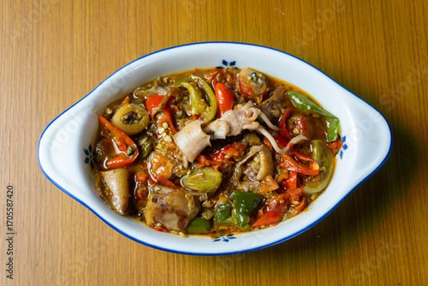 Fototapeta Cumi Asin Cabe Hijau, Salted Squid with Green Chili,  traditional Indonesian dish. Made from salted, dried squid that is stir-fried with green chilies, green tomatoes, and various spices. 