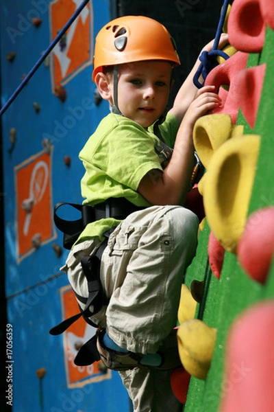 Fototapeta Boy on climbing wall