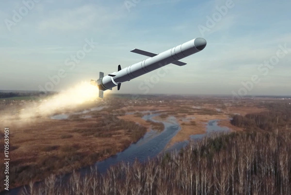 Fototapeta A Russian cruise missile is flying over a river valley, the tail flame from the engine.