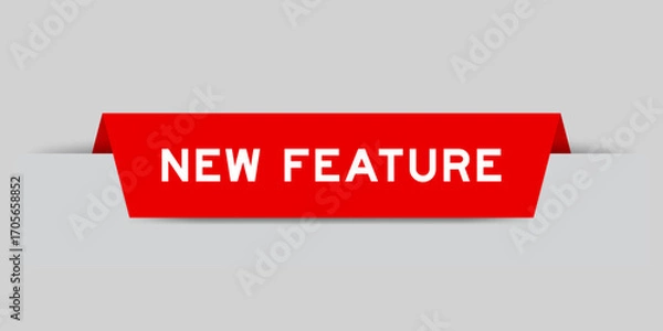 Fototapeta Red color inserted label with word new feature on gray background