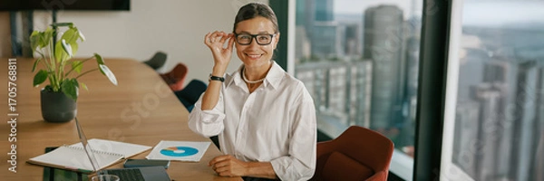 Fototapeta A Business Professional engaging in productive activities within a contemporary meeting space