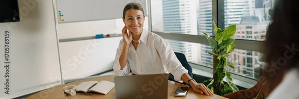 Fototapeta A professional woman confidently working in a modern office environment and setting