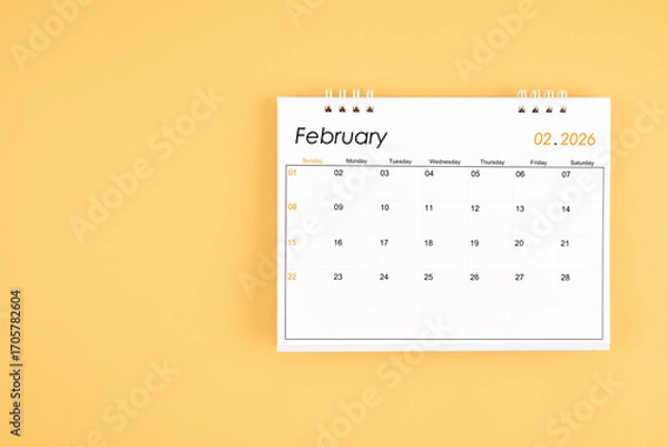 Fototapeta February 2026 desk calendar on yellow color background, position with copy space.