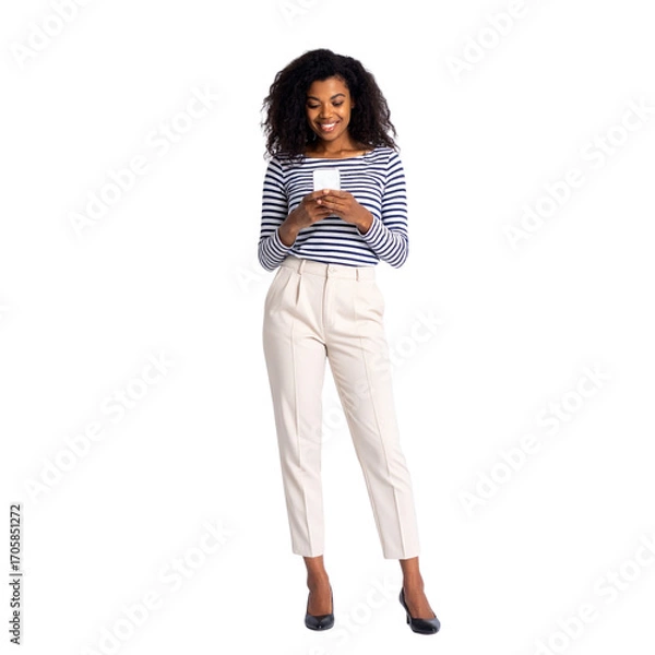 Obraz A beautiful young woman is smiling while holding and texting on a tablet and a cell phone