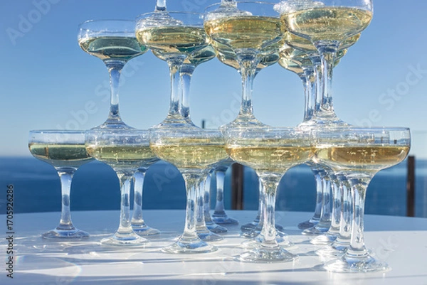 Fototapeta Champagne tower of sparkling wine glasses