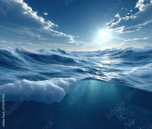 Fototapeta Ocean view bright sun piercing blue waters with fluffy clouds above. Waves crash, sunlight beams underwater, creating a serene aquatic scene