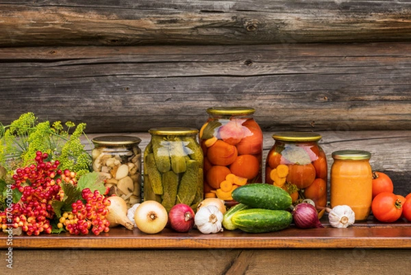 Fototapeta Canned tomatoes, mushrooms, cucumbers, and vegetables onions, garlic.