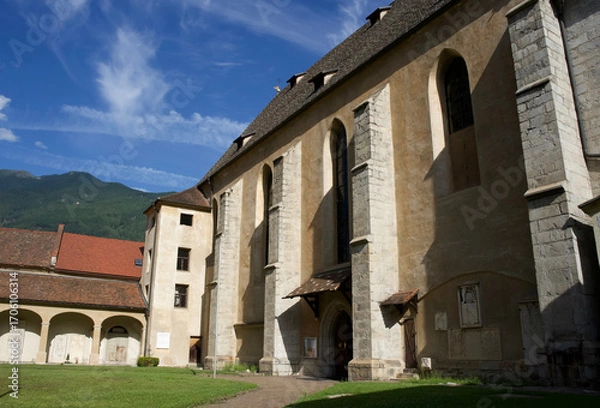 Fototapeta  Historic stone church with tall columns and beautiful blue sky in the background, showcasing architectural details