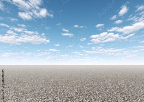 Fototapeta A vast, flat, pebble-strewn expanse meets a bright blue sky dotted with fluffy white clouds, evoking a sense of open space and tranquility