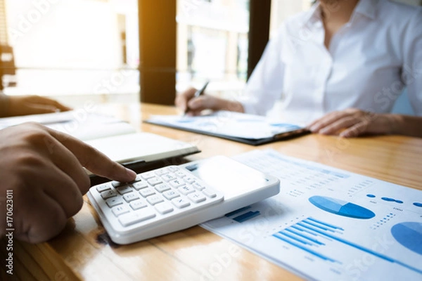 Fototapeta business audits using a calculator financial data investment fund at a workplace, wealth concept