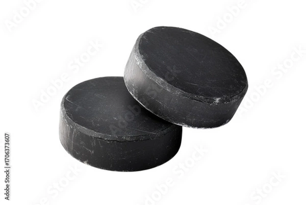 Fototapeta Two black hockey pucks stacked and isolated on a seamless dark surface