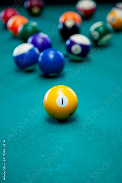 Fototapeta Billiard balls set up in starting position with cue stick approaching on green table