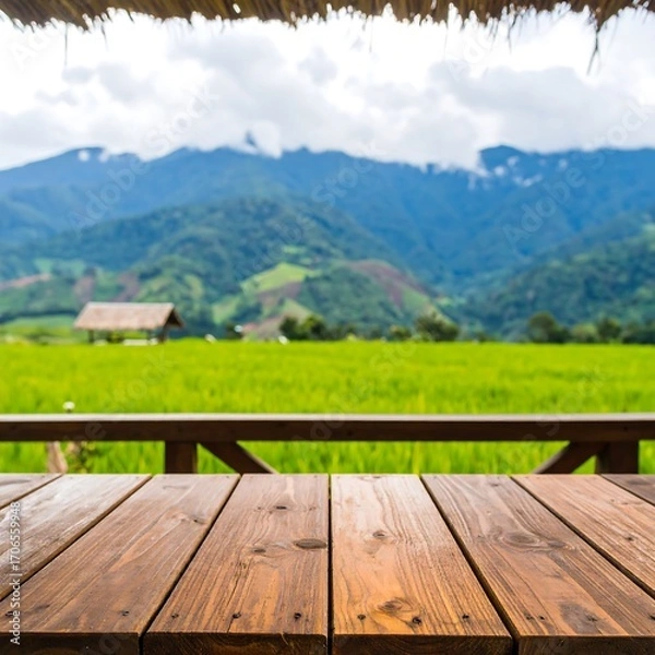 Fototapeta Rustic wooden table overlooking a rice paddy and mountains