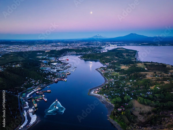 Obraz An aerial view of Puerto Montt's Canal de Tenglo and Tenglo Island during the blue hour, with a full moon reflecting on the water and the Osorno volcano in the distance.