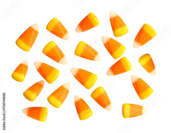 Obraz Lots of gummy corn candy for Halloween isolated on white background. Cut out image, chewy gummy orange candies.