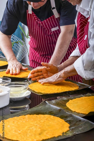 Obraz Generations collaborate on making hallaca dough