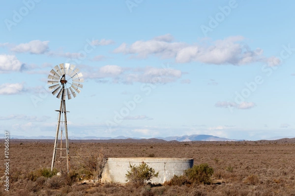 Obraz Windmill with a dam in the field