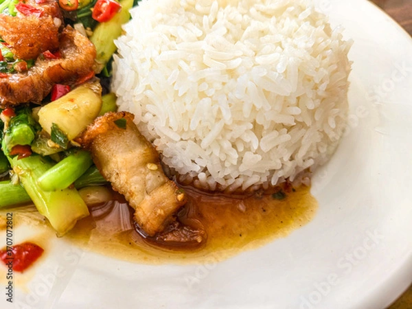 Fototapeta Crispy Pork with Stir-Fried Chinese Kale over Steaming Jasmine Rice
