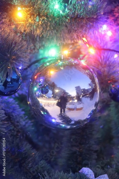 Fototapeta A persons reflection in a Christmas tree ornament