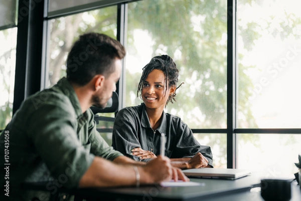 Fototapeta Two happy diverse multiethnic business team people working, talking in corporate office