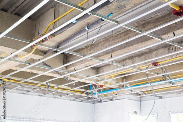 Fototapeta Ceiling construction structure and beam concrete with public utility system tube under construction.