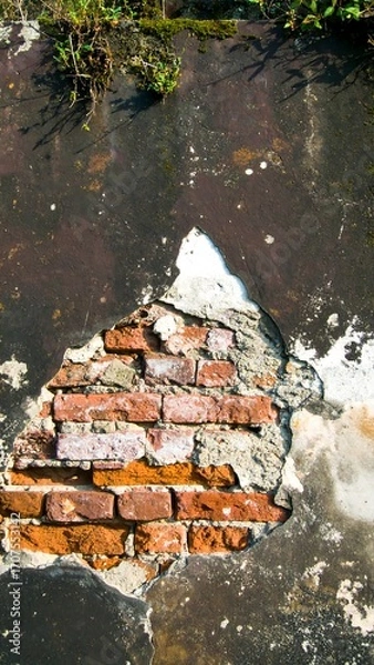 Fototapeta Weathered brick wall with a large section missing