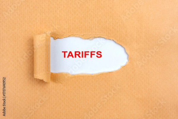 Fototapeta Tariffs text under torn paper global business concept