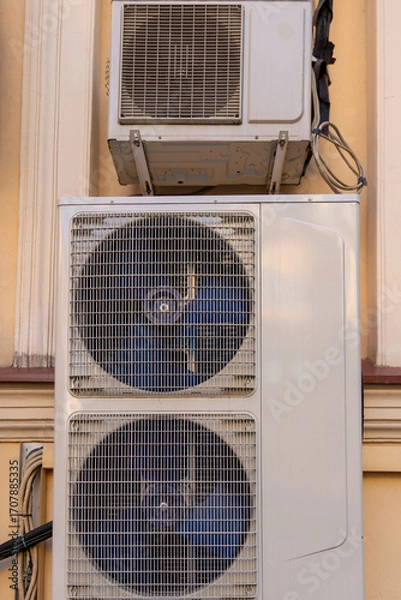Fototapeta industrial C air conditioner is installed on the facade of a house or office. ventilation and cooling system, air purification technology. split system. cooling in hot weather. climate.