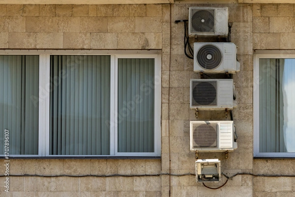 Fototapeta Air conditioners on the facade of the house, ventilation and cooling system, air purification technology. split system.